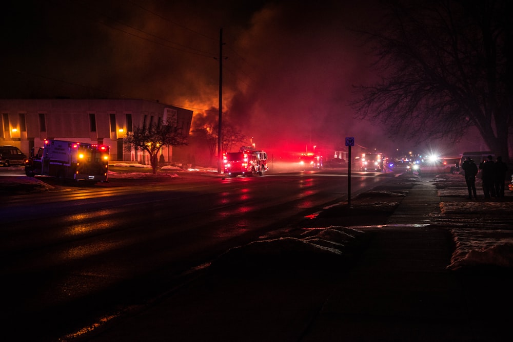 fire truck beside burning house during nighttime