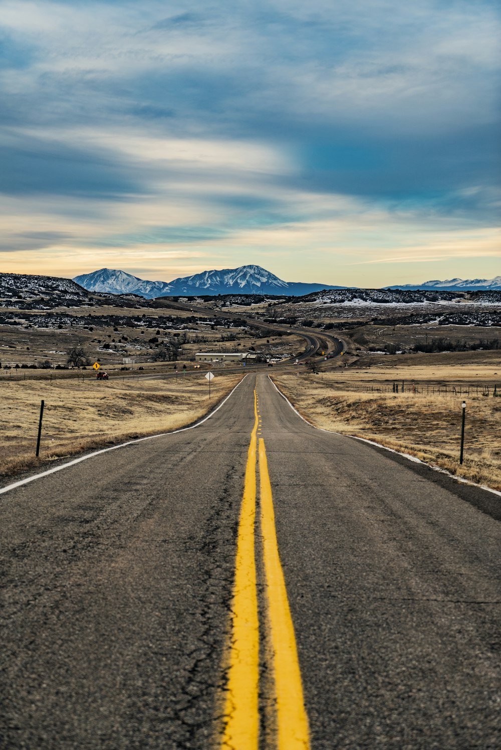 empty road under white clouds and blue sky