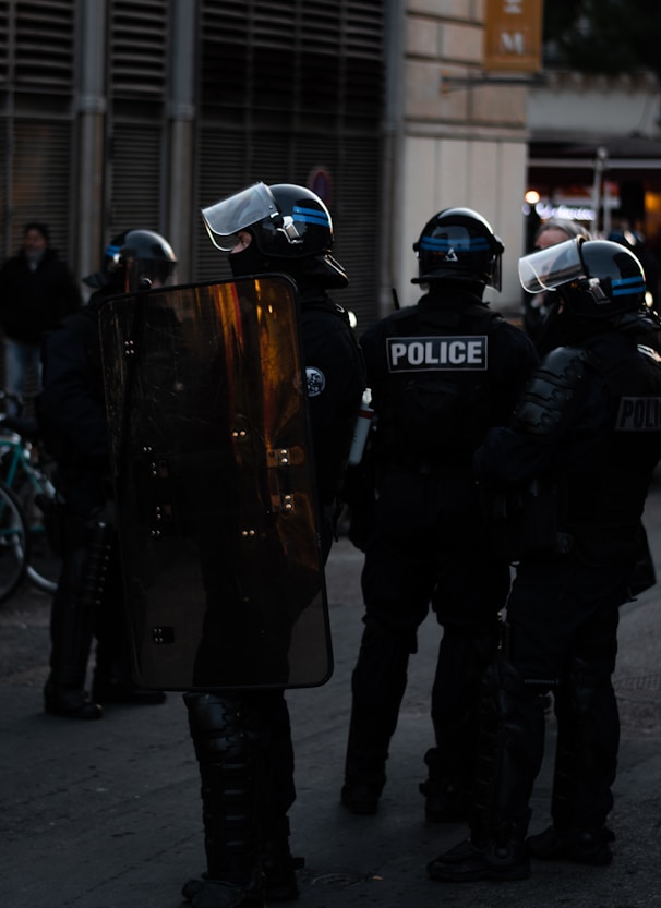 men wearing Police uniforms standing outside buildings at daytime