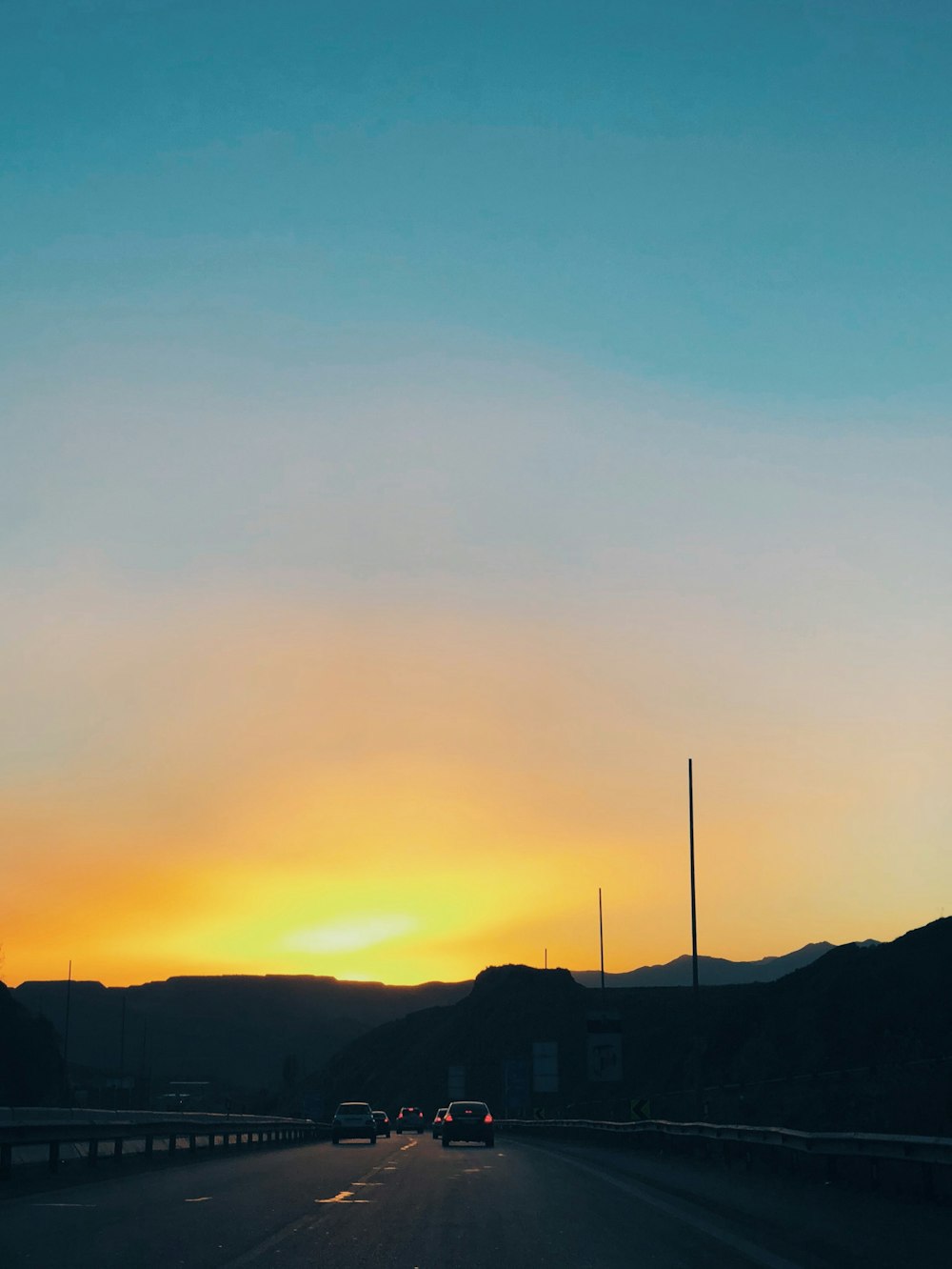 vehicle traveling on road during sundown