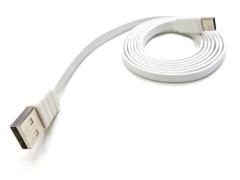 Various USB cables coiled neatly on a white background.