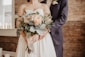 woman holding beige-petaled flower bouquet