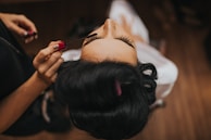 Bridal prep makeup—eyelash touch-up before the ceremony, Glasgow wedding videography detail.