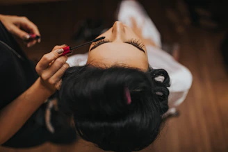 Bridal prep makeup—eyelash touch-up before the ceremony, Glasgow wedding videography detail.