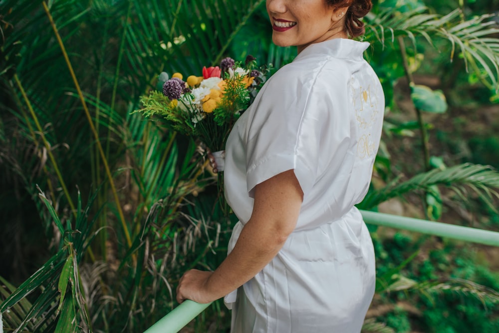 smiling woman holding flowers bouquet