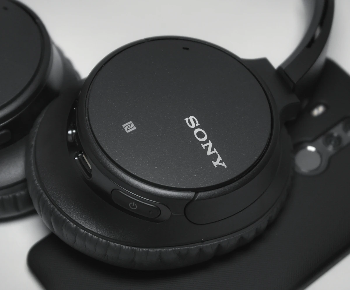 Sony WH-1000XM7 headphones showing the NFC pairing icon, power button and redesigned ear cushions