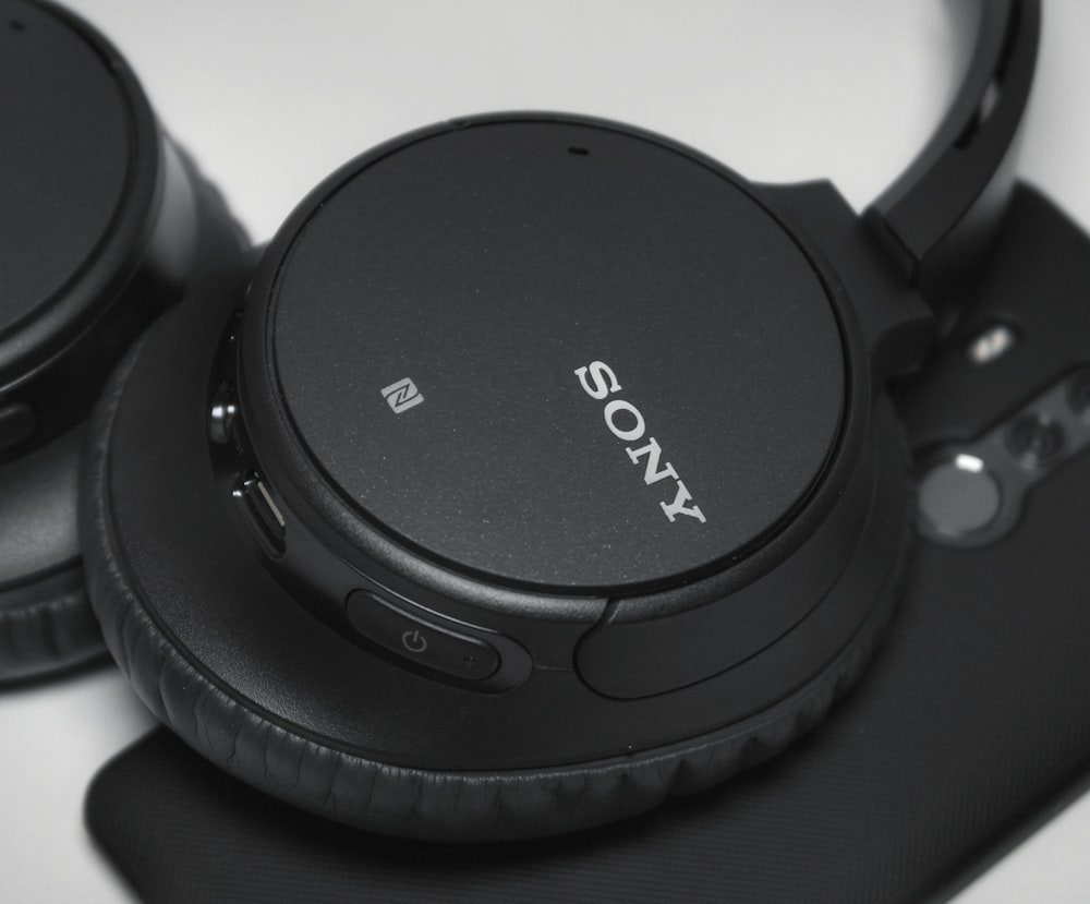 black Sony cordless headphones on white surface