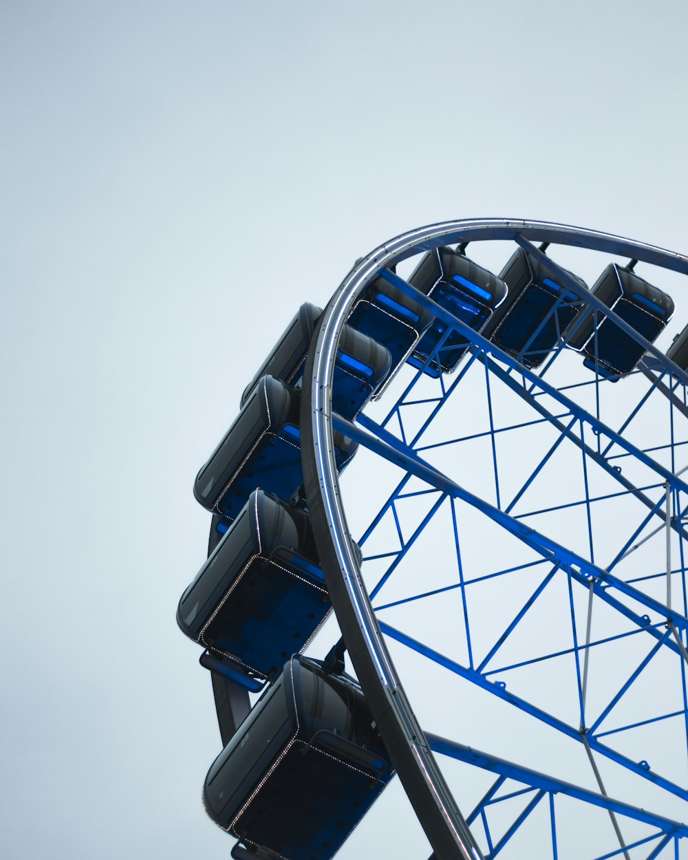 low-angle photography of black and blue ferris wheel