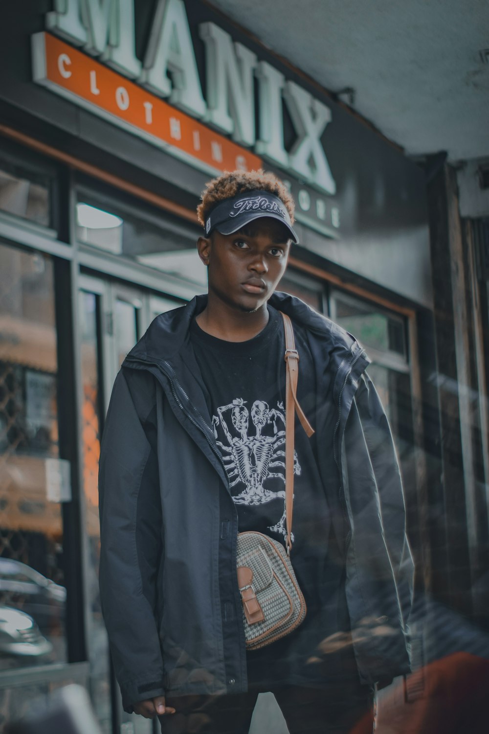 man standing near store door