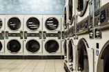 white washer and dryer laundry centers on white floor tiles
