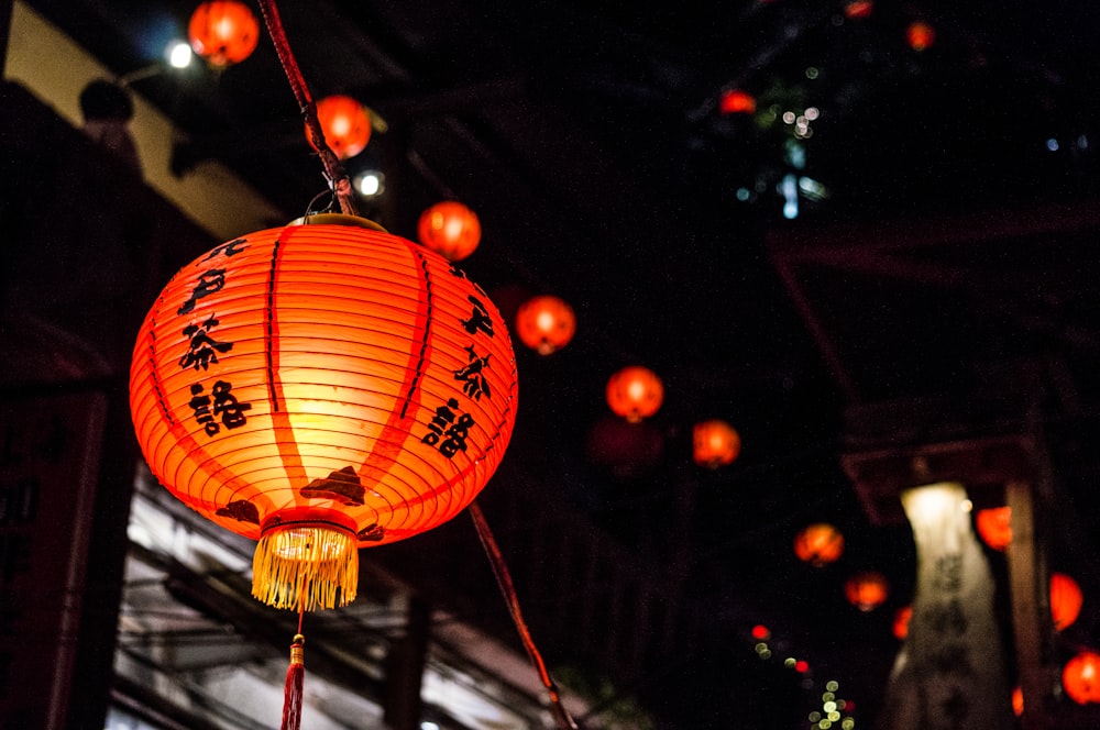 selective focus photography of red and black Japanese lantern