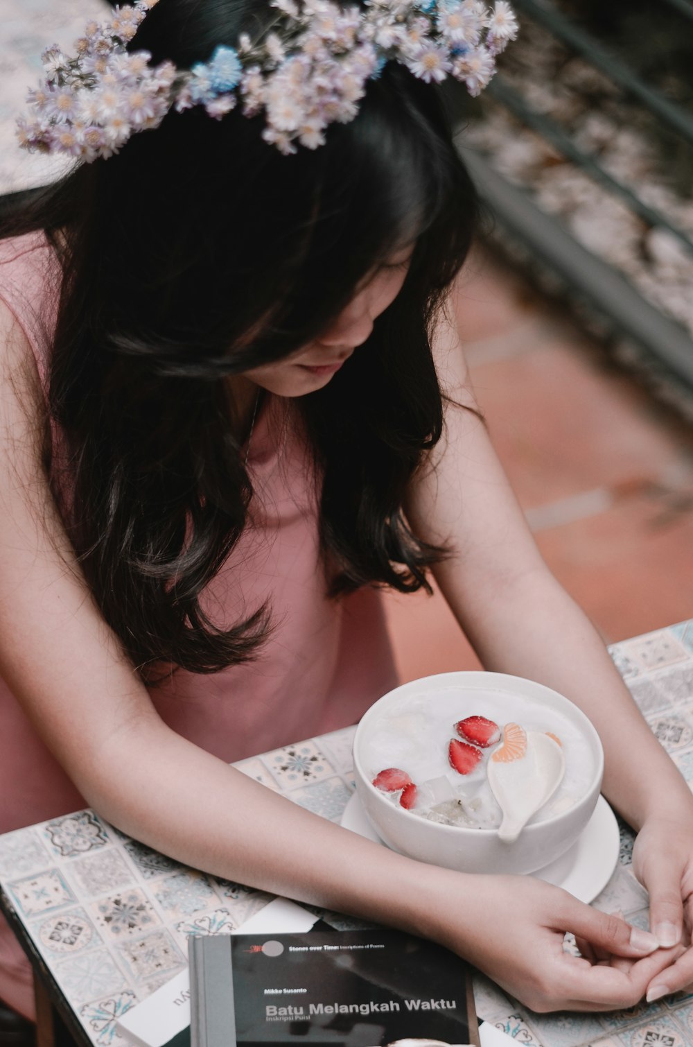 selective focus photography of woman sitting at table with food
