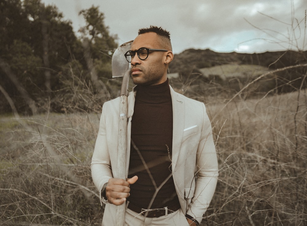 man standing on brown grass