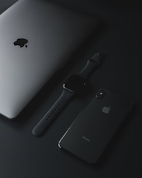 An elegant display of luxury tech products arranged on a clean, white surface with soft lighting.