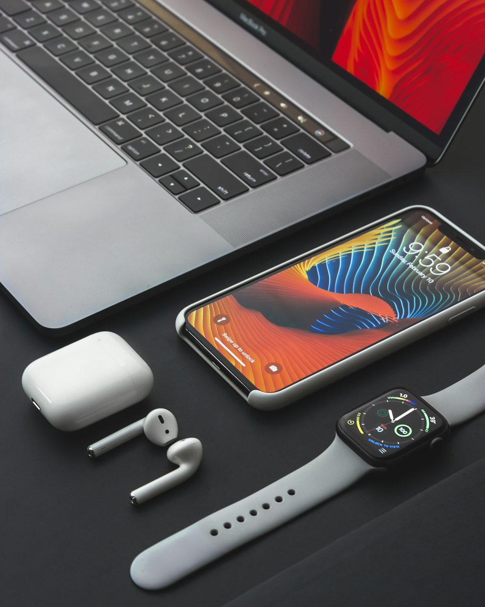 Space gray iphone x turned on beside apple airpods and charging case photo  – Free Electronics Image on Unsplash