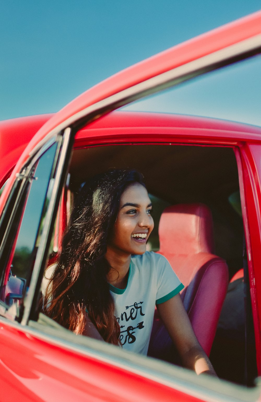 woman riding red car