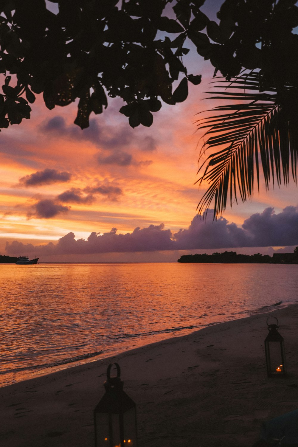 lighted lamps on sand during sunset