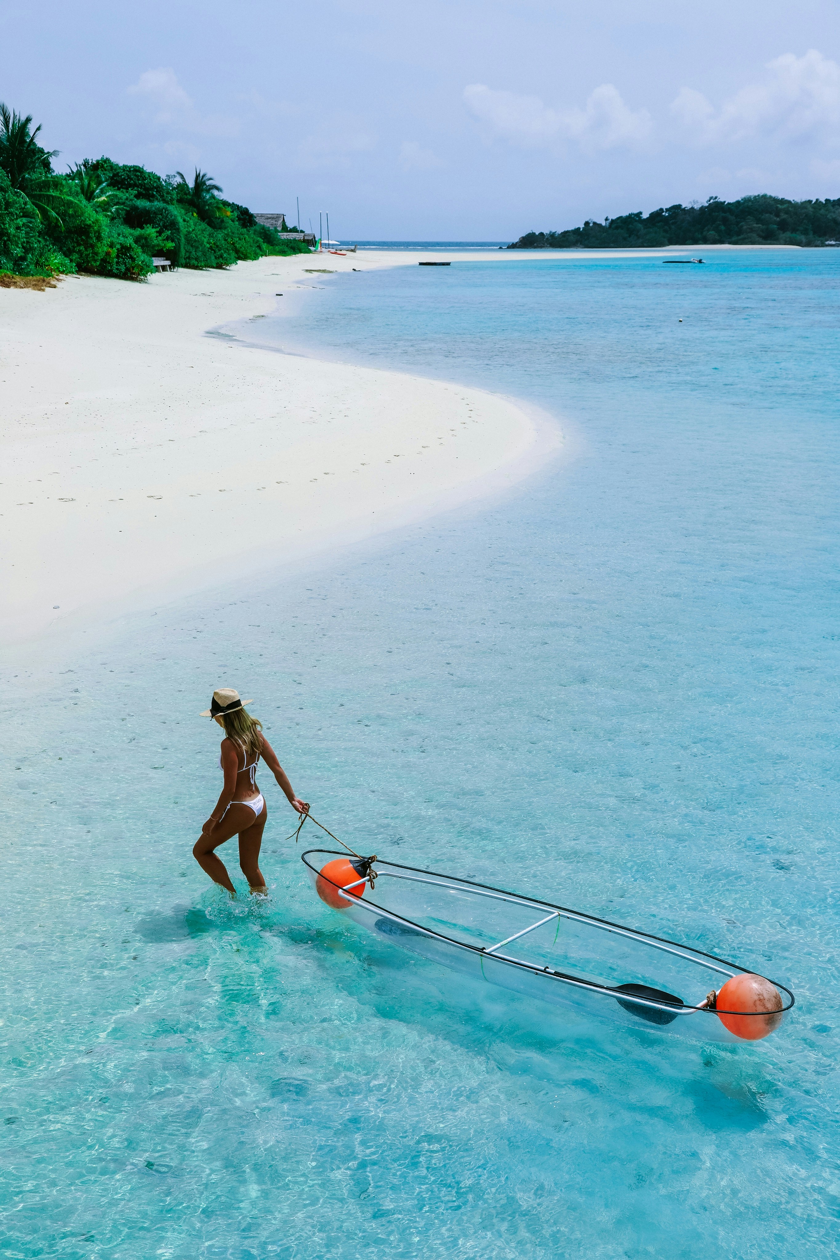 woman holding surfboard on shore