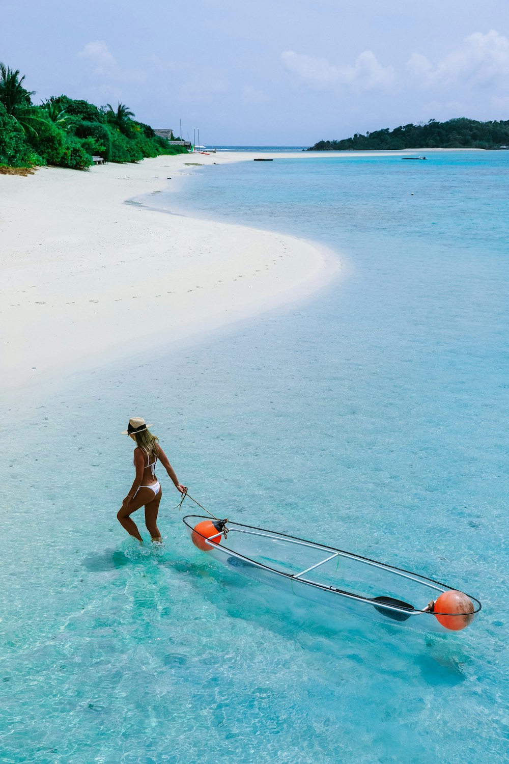 woman holding surfboard on shore