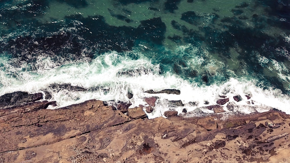 a bird's eye view of the ocean and rocks