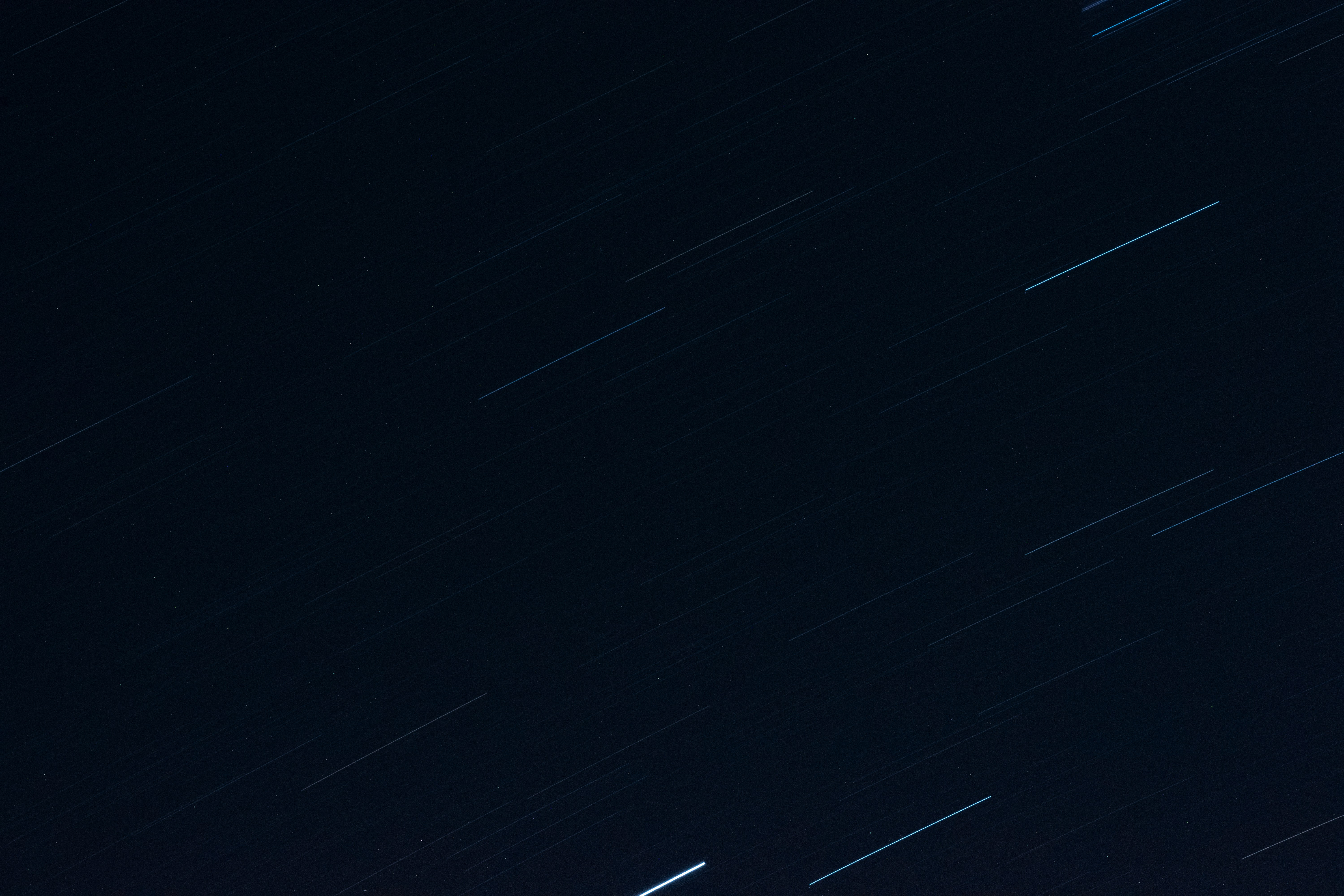 a night sky with stars and a line of stars in the sky