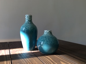 A sunlit display of vases with cracks and ridges highlighting their handcrafted artistry.