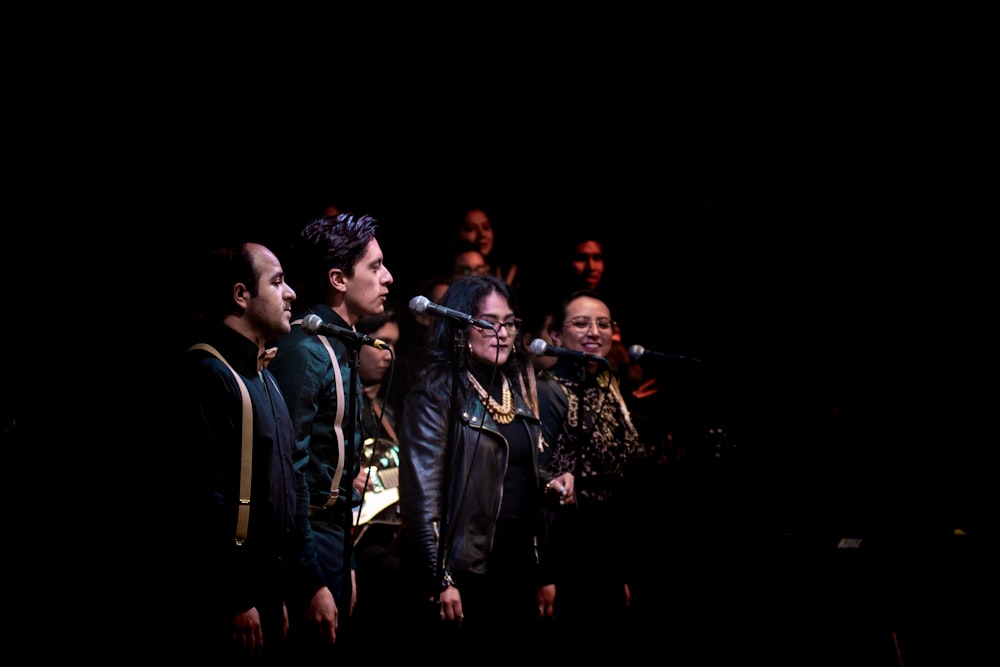 people standing on stage performing song