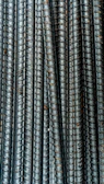 Close-up of stacked FE 500 grade TMT bars with a textured steel surface.