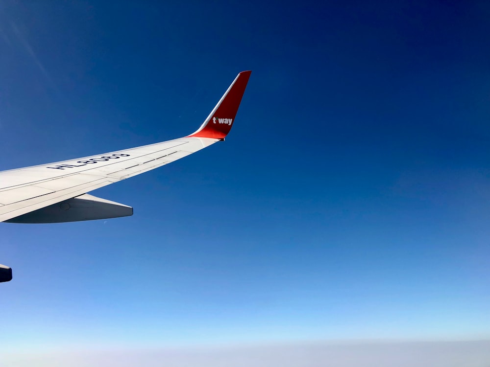 gray airplane flying during daytime