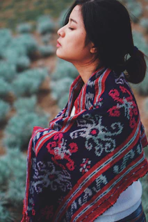 shallow focus photo of black, gray, and red scarf
