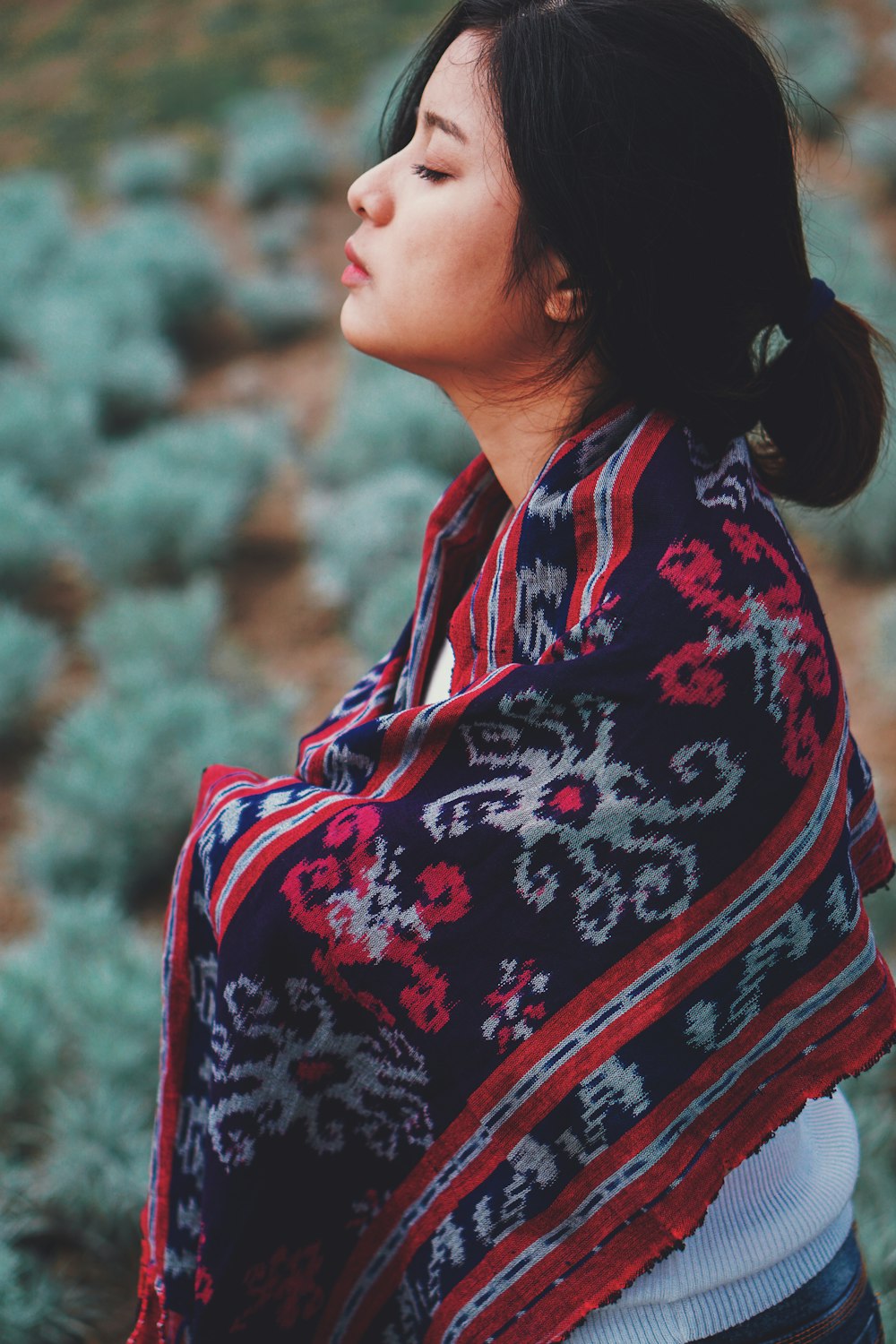 shallow focus photo of black, gray, and red scarf