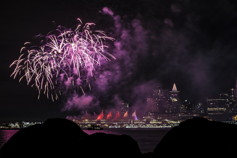 fireworks above city skyline at night-time