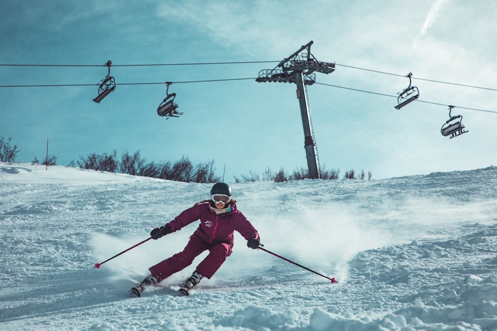 person doing snow ski under cable cars