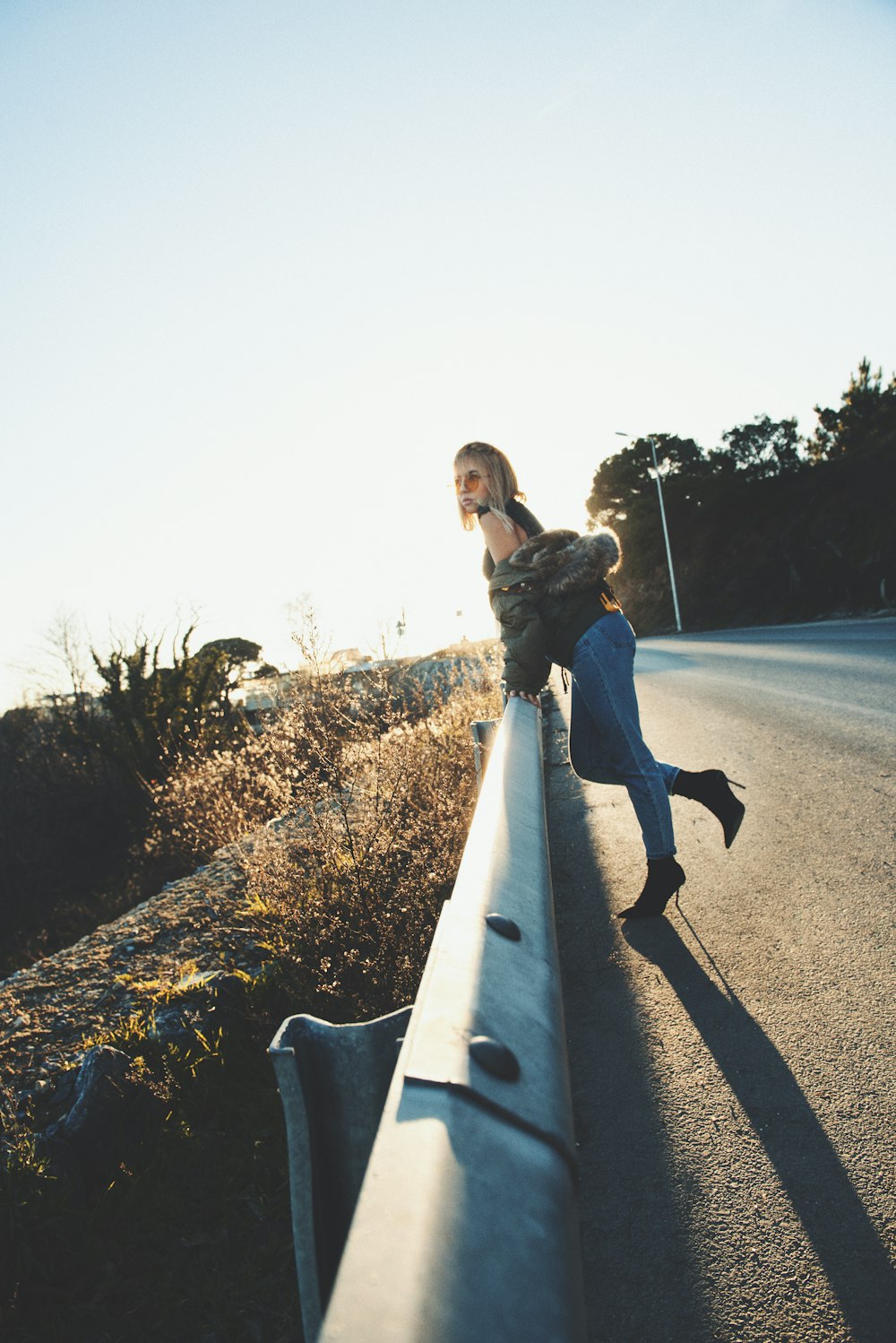 woman standing on metal railings