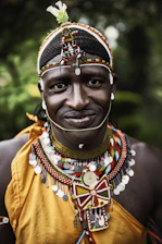 selective focus photography smiling man wearing multicolored costume
