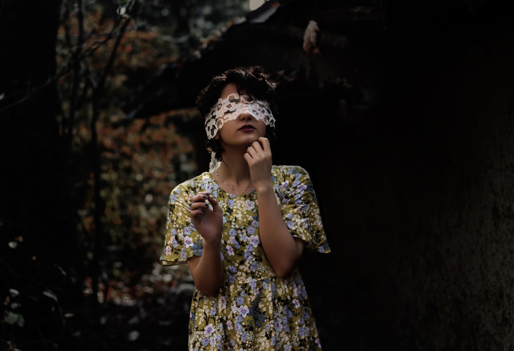 woman blindfolding while walking during daytime