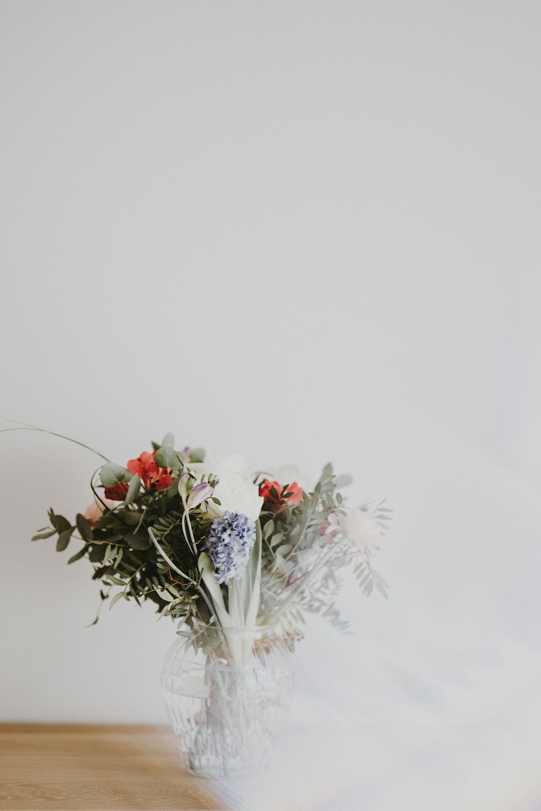 multicolored flower in vase on table