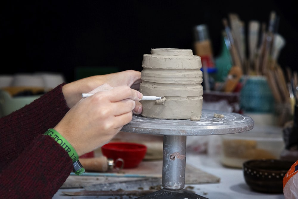 person carving pot