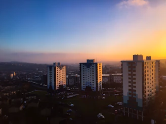 A vibrant cityscape showing new apartment buildings in Lima neighborhoods at sunset