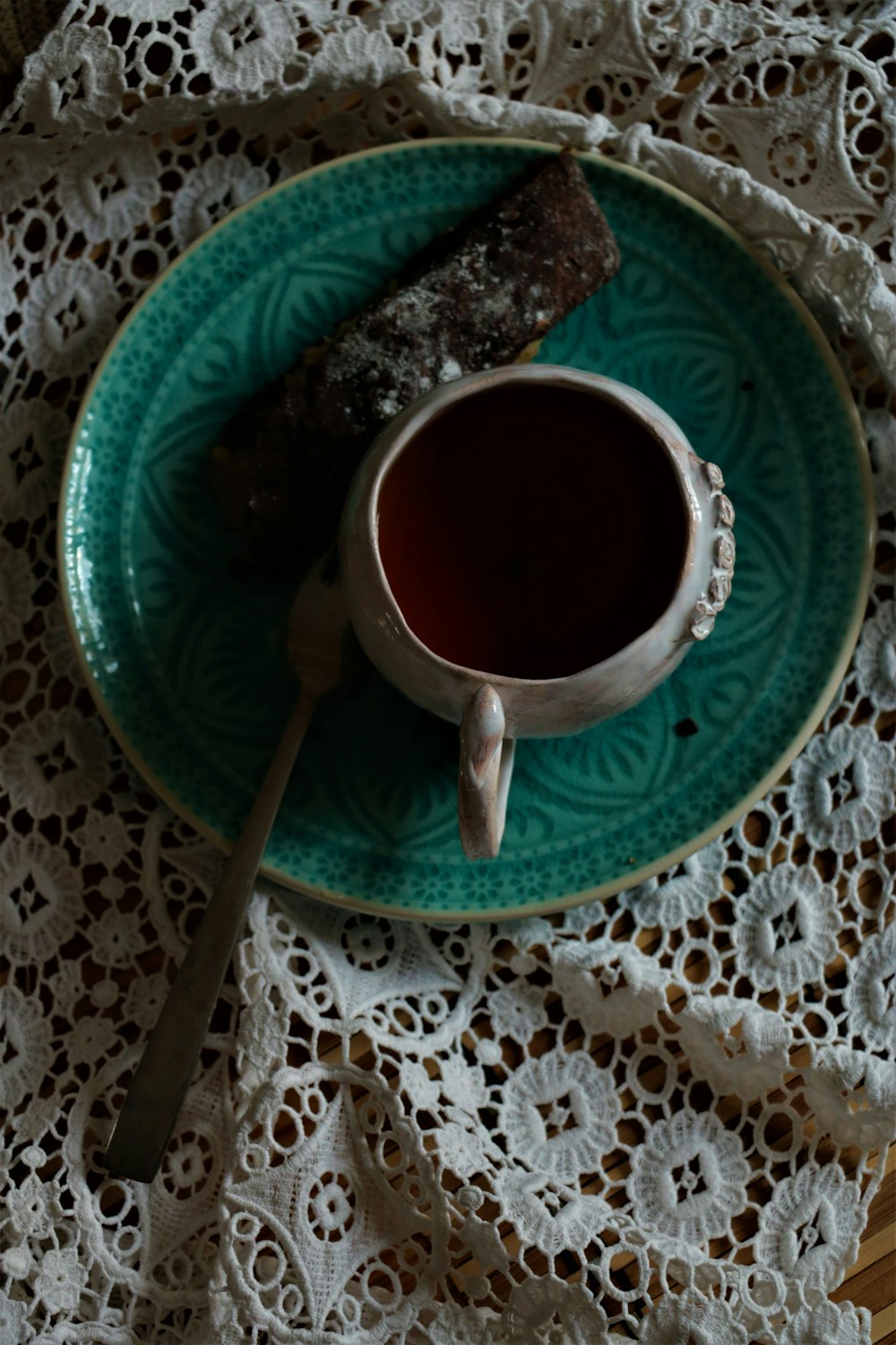 filled white ceramic mug with dessert on blue plate