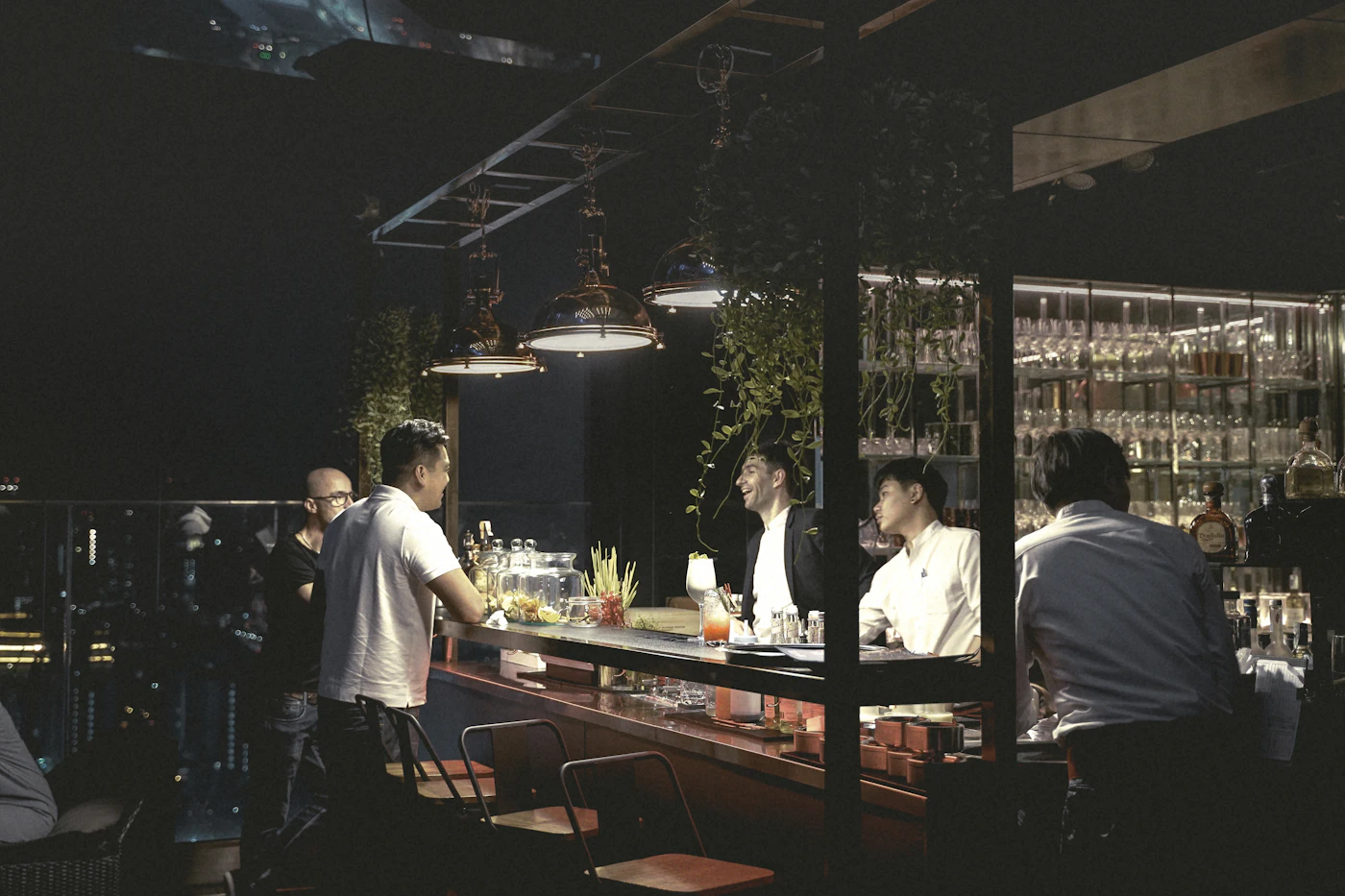 Guests seated at a bar in a private lounge