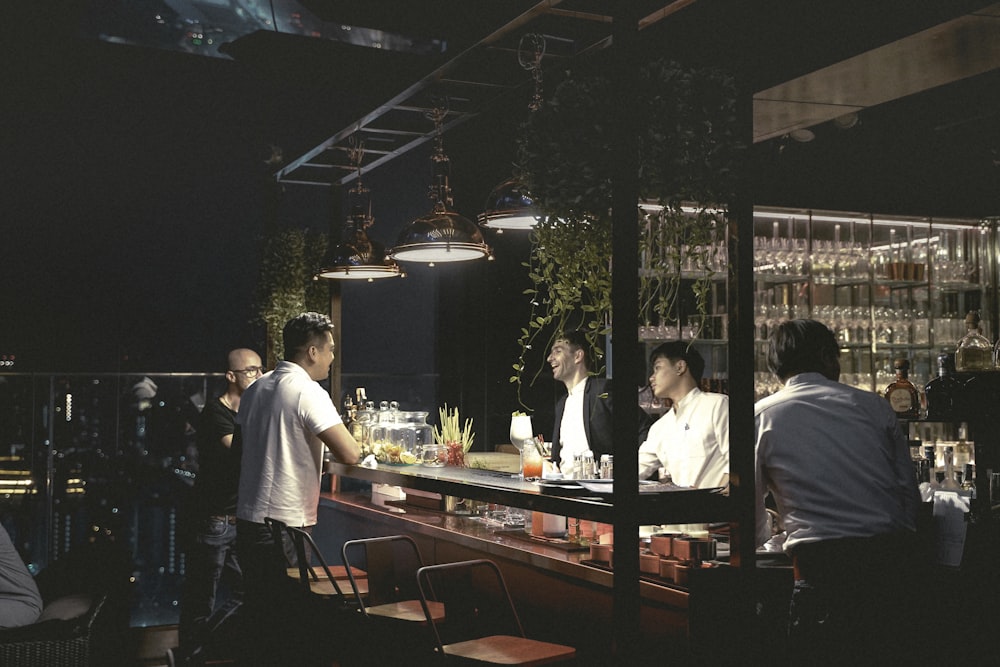 men sitting on bar stools