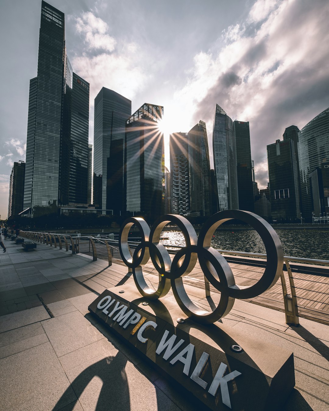olympic walk signage near body of water