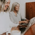 two women using laptops