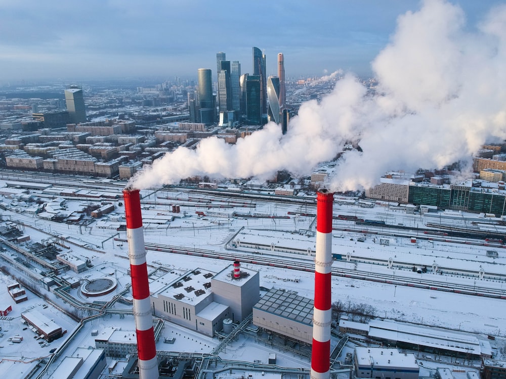 red-and-white pipe with smoke during daytime