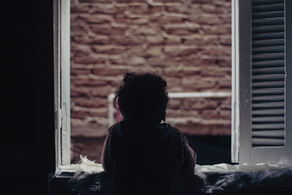 child looking outside the window