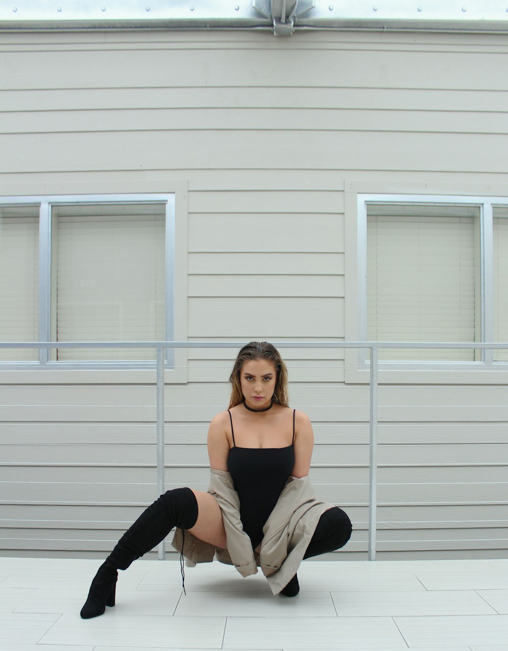 woman sitting behind rail