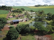 A lush green farm with solar panels and water tanks, showing sustainable infrastructure.
