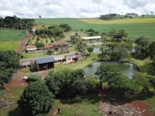 Aerial view of a sustainable farm using geotechnology tools under clear skies.
