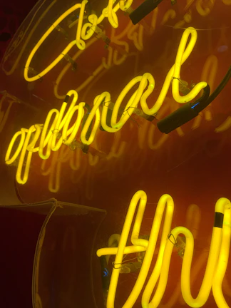 Custom metal sign with bold lettering glowing under workshop lights.